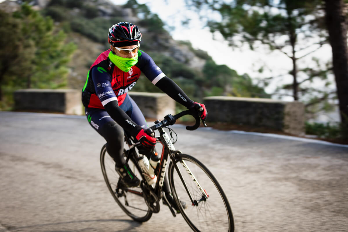 Sports cyclist racing down hill on cycle holidays Sierra de Grazalema Spain